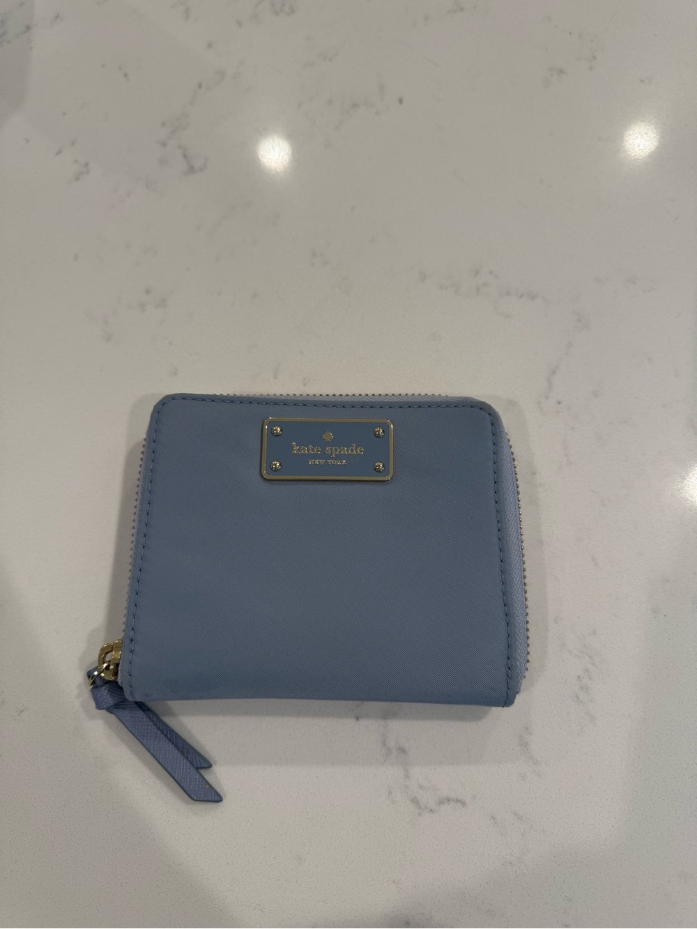 kate spade small zip-around wallet in powder blue with gold-tone plate